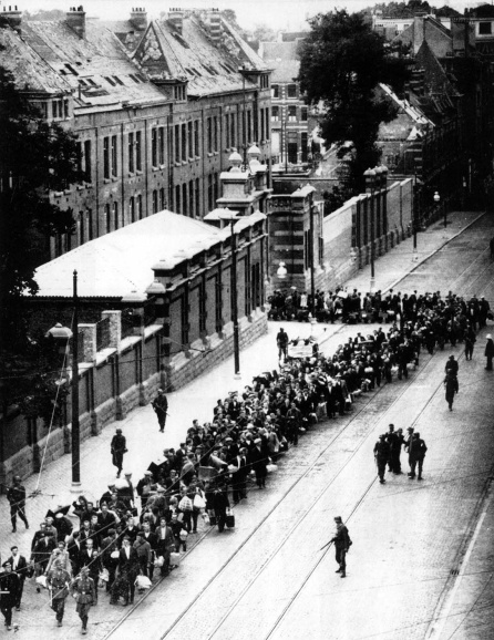 Een kolonne werkweigeraars werd weggevoerd uit de kazerne van Etterbeek, voor deportatie naar Duitsland, 1940-1944. (CegeSoma/Rijksarchief, 4764)